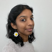 Load image into Gallery viewer, Handmade lightweight paper quilled earrings in a Daisy flower shape. White &amp; Yellow color., work on model.
