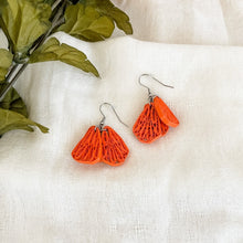 Load image into Gallery viewer, Handmade paper quilled lightweight earrings inspired by California Poppy flower. This is a deconstructed form. It has 3 orange petals hanging together.
